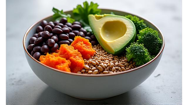 A colorful bowl of plant-based food, possibly a Buddha bowl, with various vegetables, grains, and legumes, signifying healthy eating.